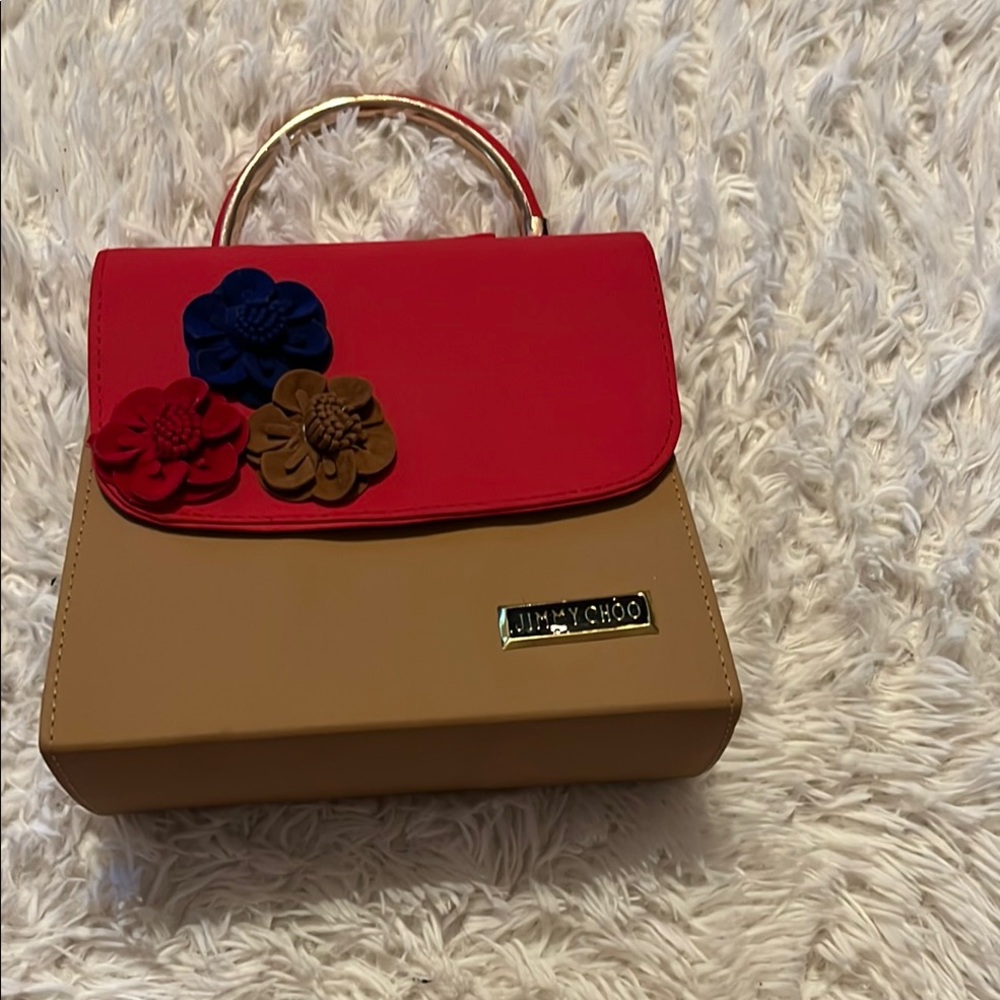 The bag has Jimmy Choo on the front Red and Tan Women's Bag